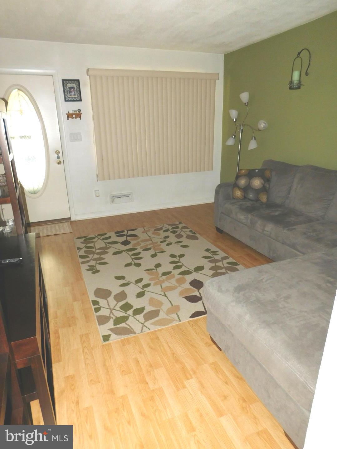 7708 Charlesmont Road Baltimore, MD 21222 - Photo 5 of 28 a view of a livingroom with wooden floor and a rug
