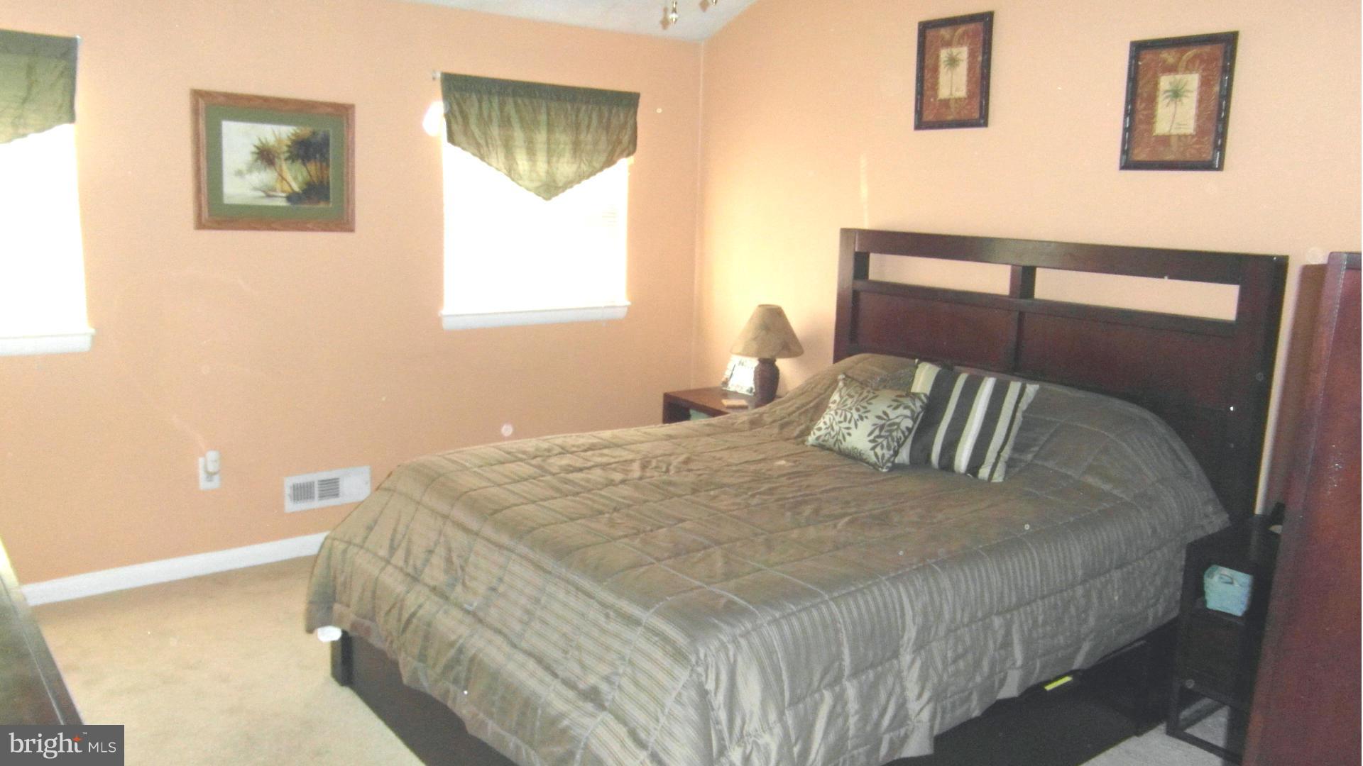 7708 Charlesmont Road Baltimore, MD 21222 - Photo 10 of 28 a bedroom with a bed and a window