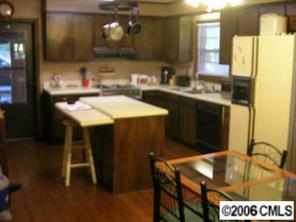 307 Florence Road Statesville, NC 28625 - Photo 4 of 7 a kitchen with a sink a stove and chairs