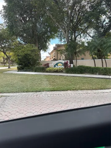 a view of a park with large trees