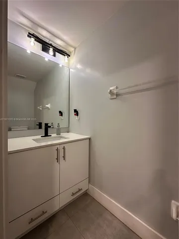 a bathroom with a double vanity sink and mirror