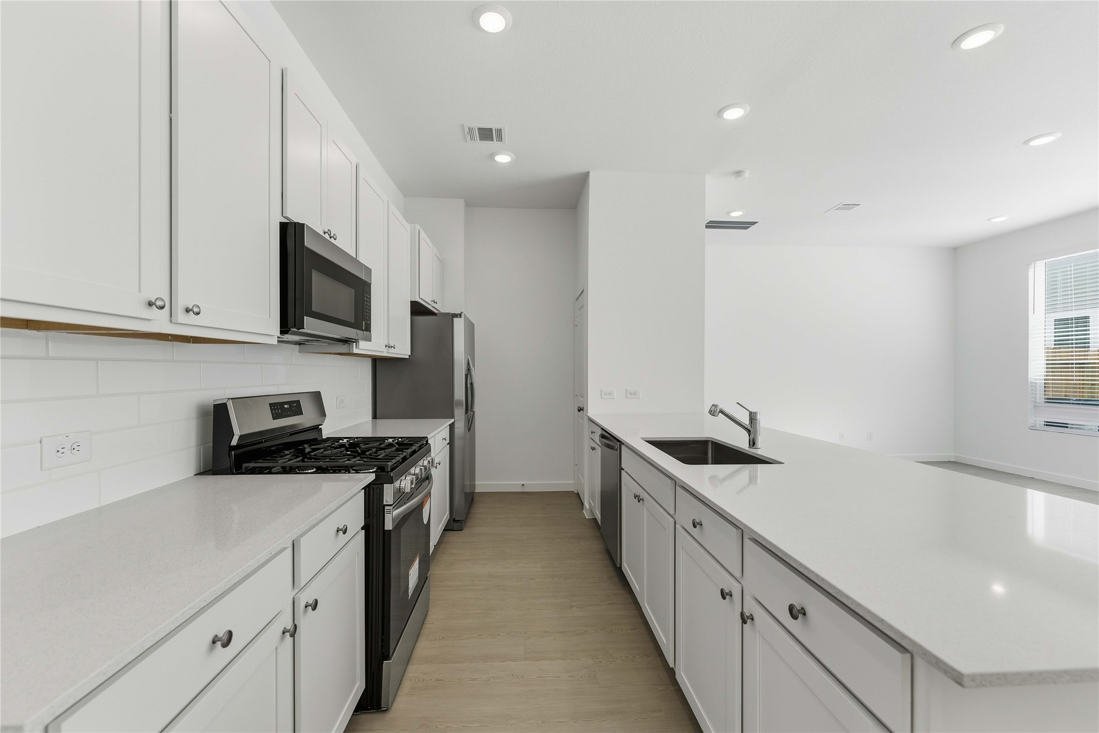 2206 Via Isa Lane Houston, TX 77051 - Photo 6 of 30 a kitchen with stainless steel appliances a sink stove top oven and cabinets