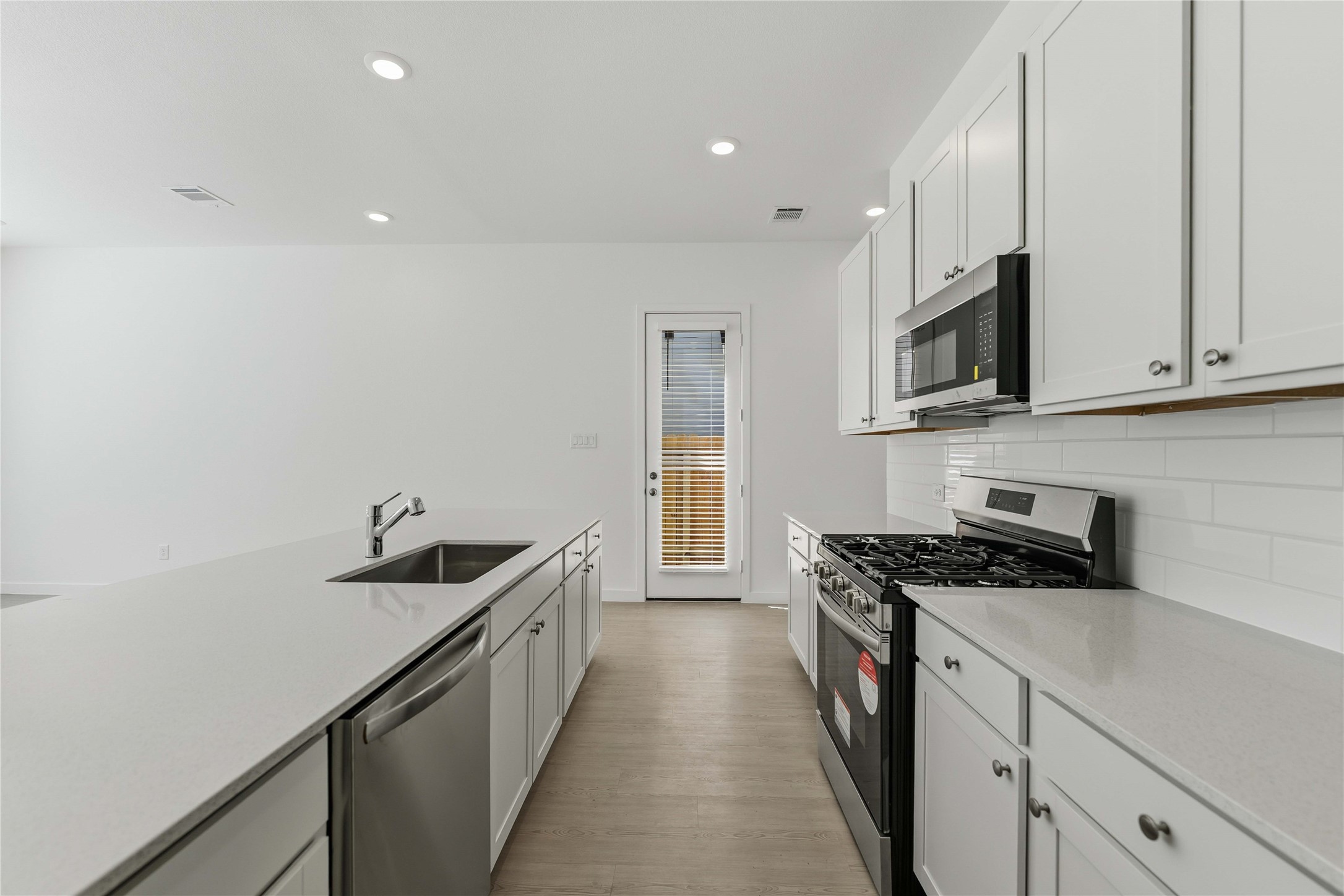 2206 Via Isa Lane Houston, TX 77051 - Photo 7 of 30 a kitchen with stainless steel appliances a sink stove and cabinets