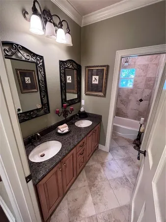 a bathroom with a double vanity sink and a mirror