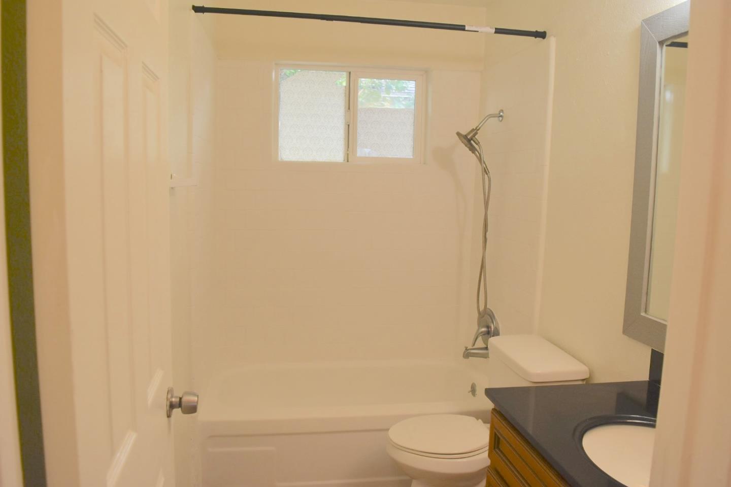 722 East Swain Road Stockton, CA 95207 - Photo 13 of 16 a bathroom with a toilet a sink and shower