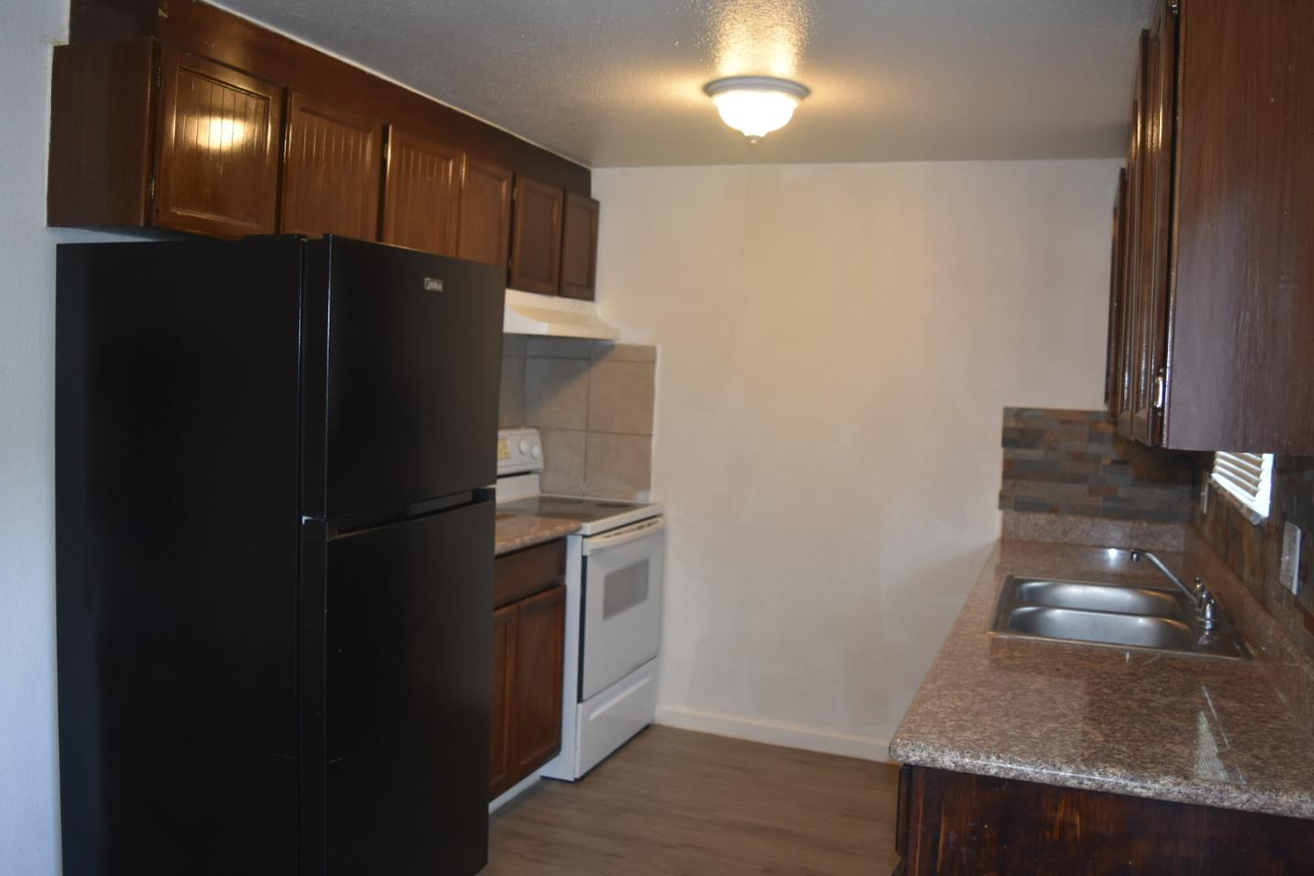 722 East Swain Road Stockton, CA 95207 - Photo 8 of 16 a kitchen with a refrigerator and a stove
