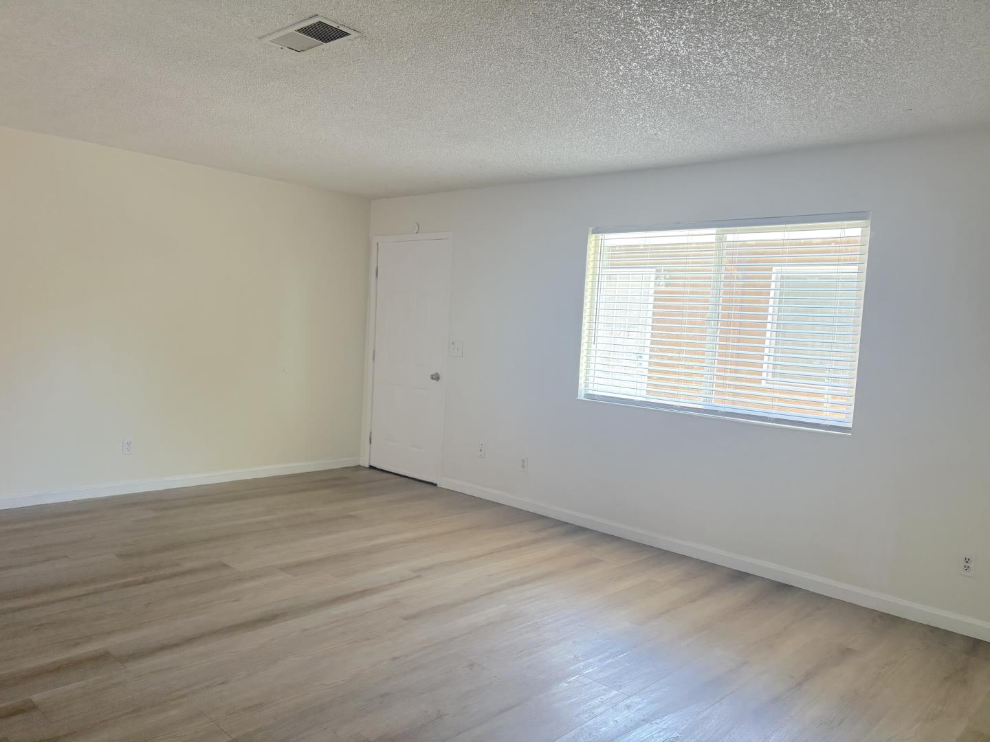 722 East Swain Road Stockton, CA 95207 - Photo 10 of 16 wooden floor in an empty room with a window
