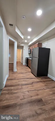 a view of a room with wooden floor