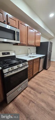 a kitchen with stainless steel appliances a stove and a microwave