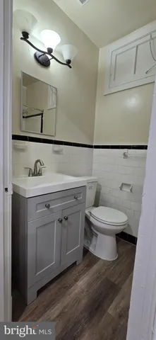 a white toilet sitting next to a bathroom sink