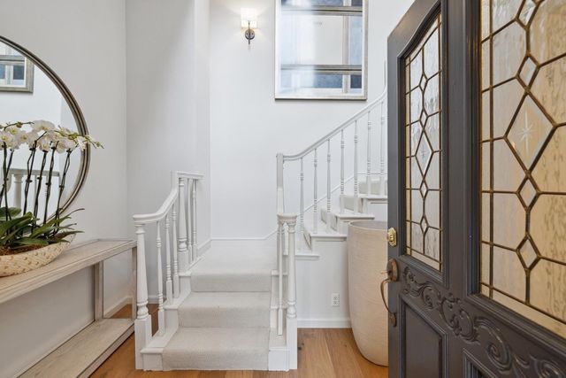 a view of balcony with wooden floor and fence