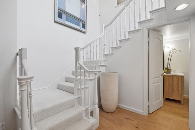 a living room with stainless steel appliances kitchen island granite countertop furniture a rug kitchen view and a chandelier