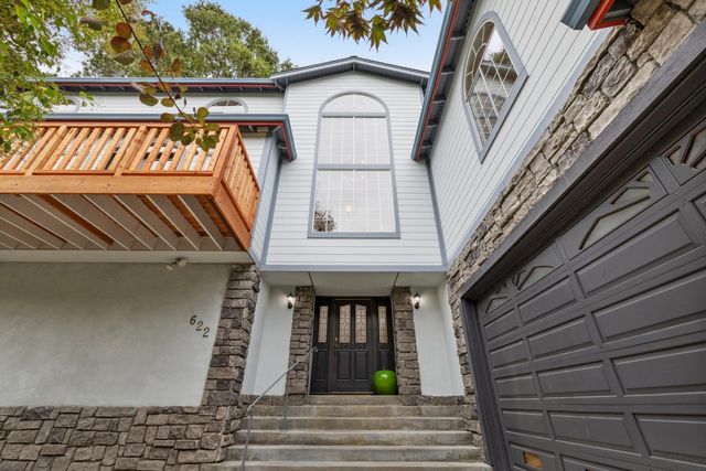 a kitchen with stainless steel appliances granite countertop a stove a sink a dining table and chairs