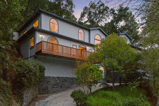 a front view of residential houses with yard and green space