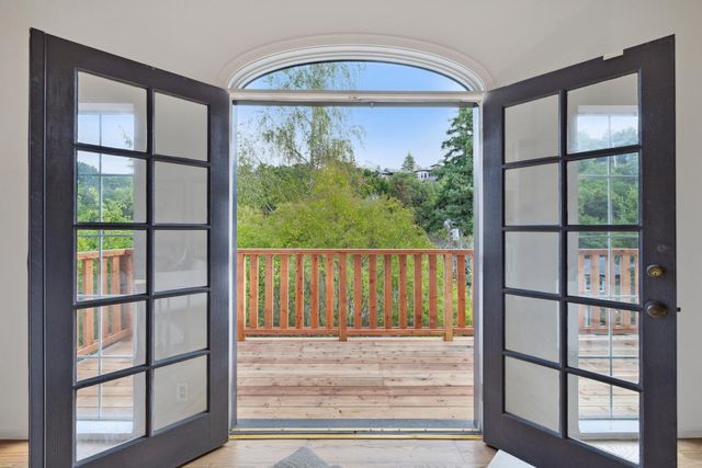 a kitchen with stainless steel appliances granite countertop a refrigerator a sink dishwasher a stove and white countertops with wooden floor