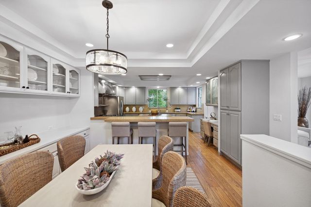 a bathroom with a granite countertop sink mirror and bathtub