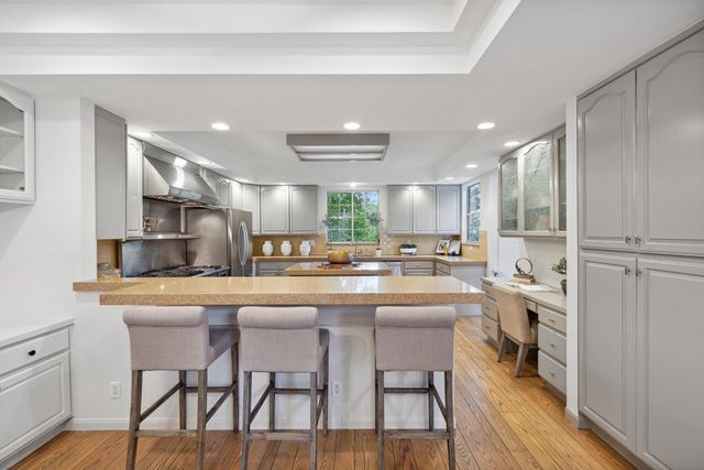 a bathroom with a tub sink shower and mirror