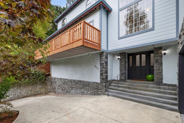 an aerial view of a house with a yard