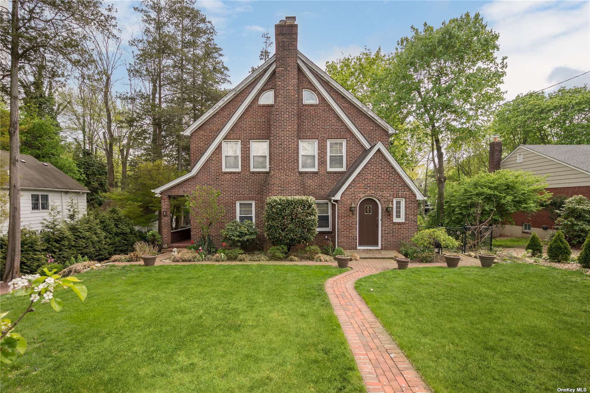 a front view of house with yard and green space