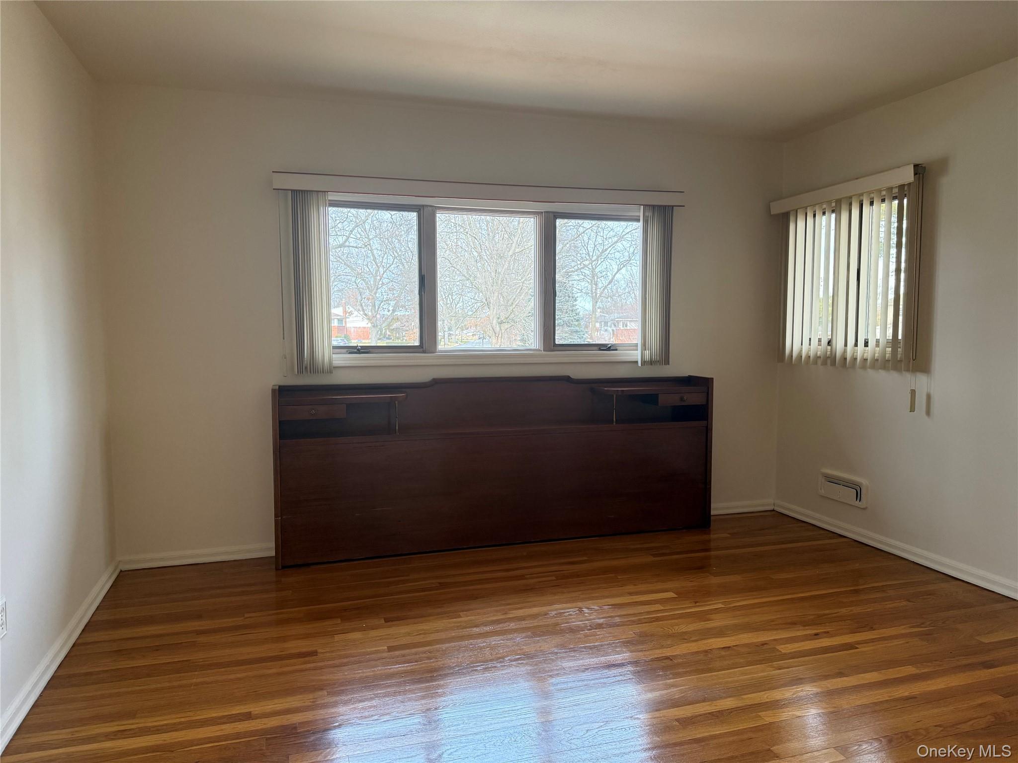 14 Genesee Drive Commack, NY 11725 - Photo 11 of 21 a room with a window and wooden floor