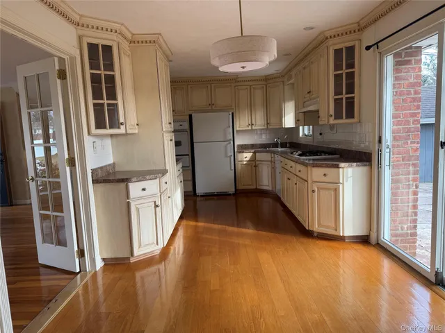 a kitchen with stainless steel appliances granite countertop a stove a sink and a refrigerator
