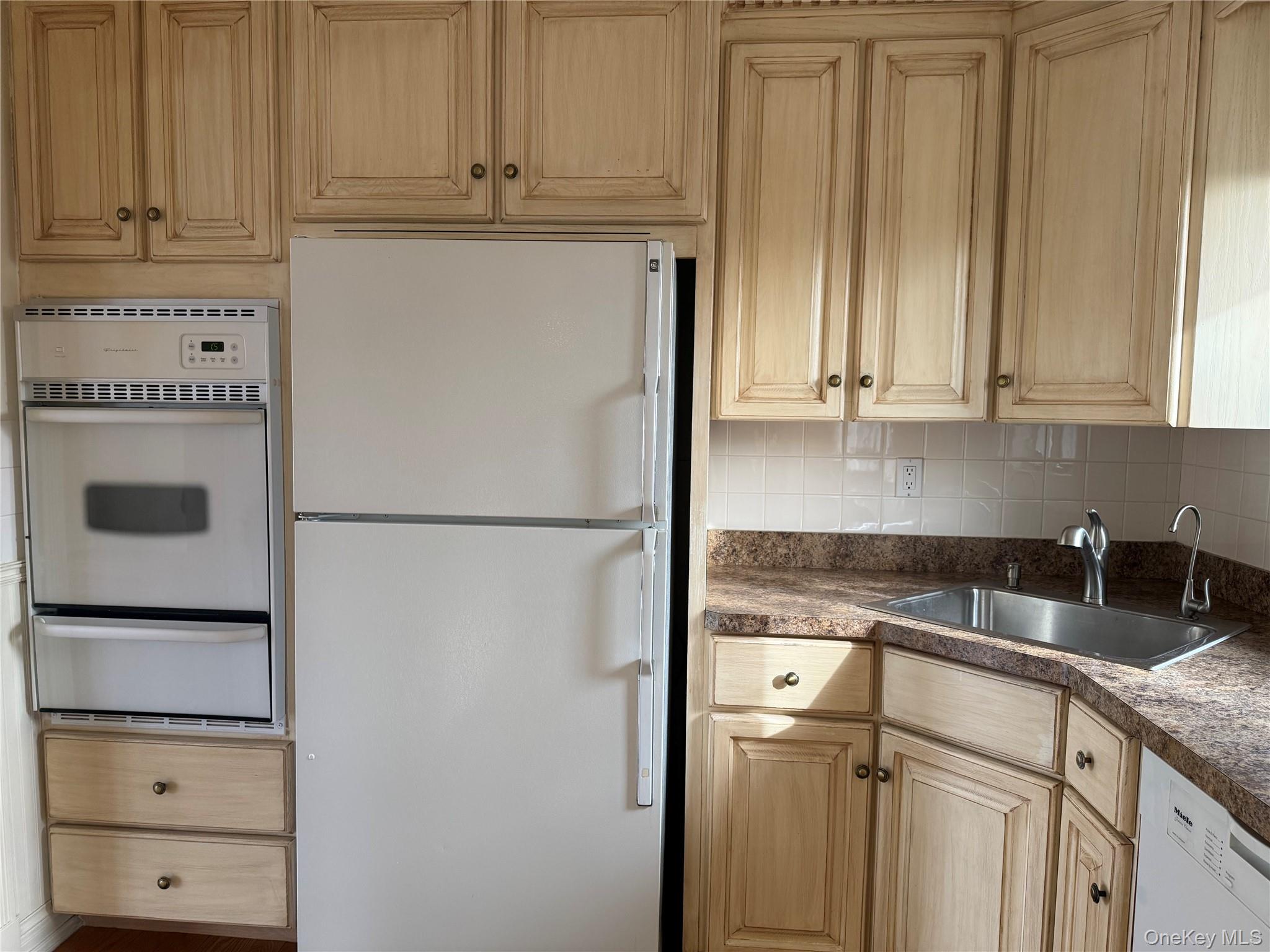 14 Genesee Drive Commack, NY 11725 - Photo 6 of 21 a kitchen with granite countertop a refrigerator and cabinets