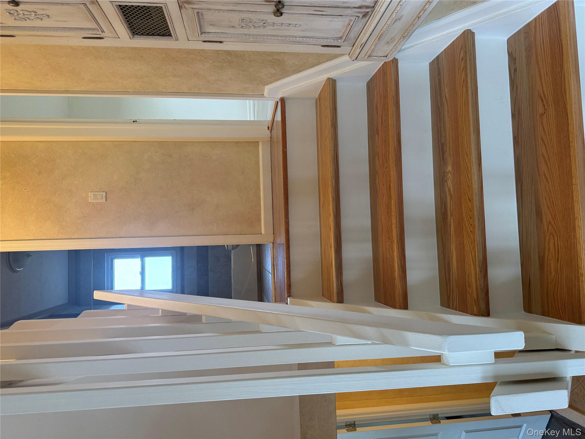 14 Genesee Drive Commack, NY 11725 - Photo 7 of 21 a view of staircase with white walls and a window