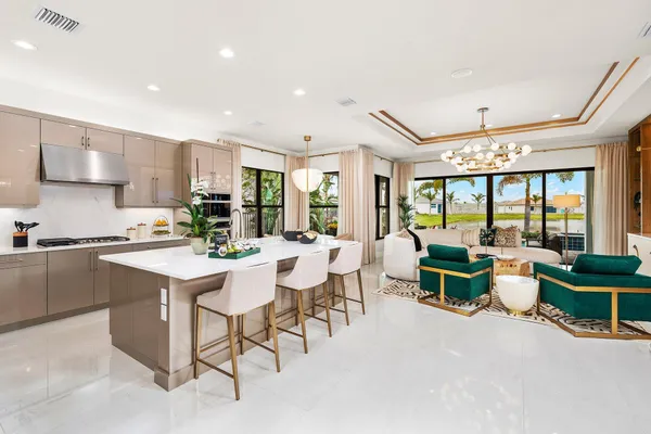 a large white kitchen with a table and chairs