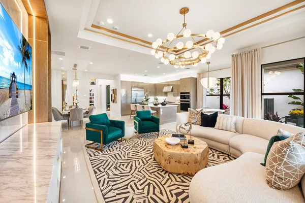 a living room with furniture and a chandelier