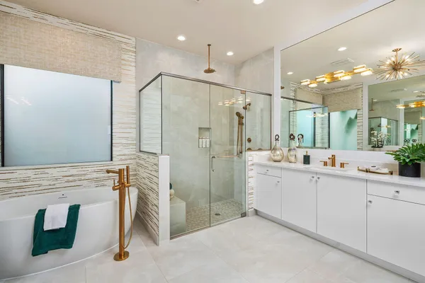 a bathroom with a double vanity sink mirror and shower