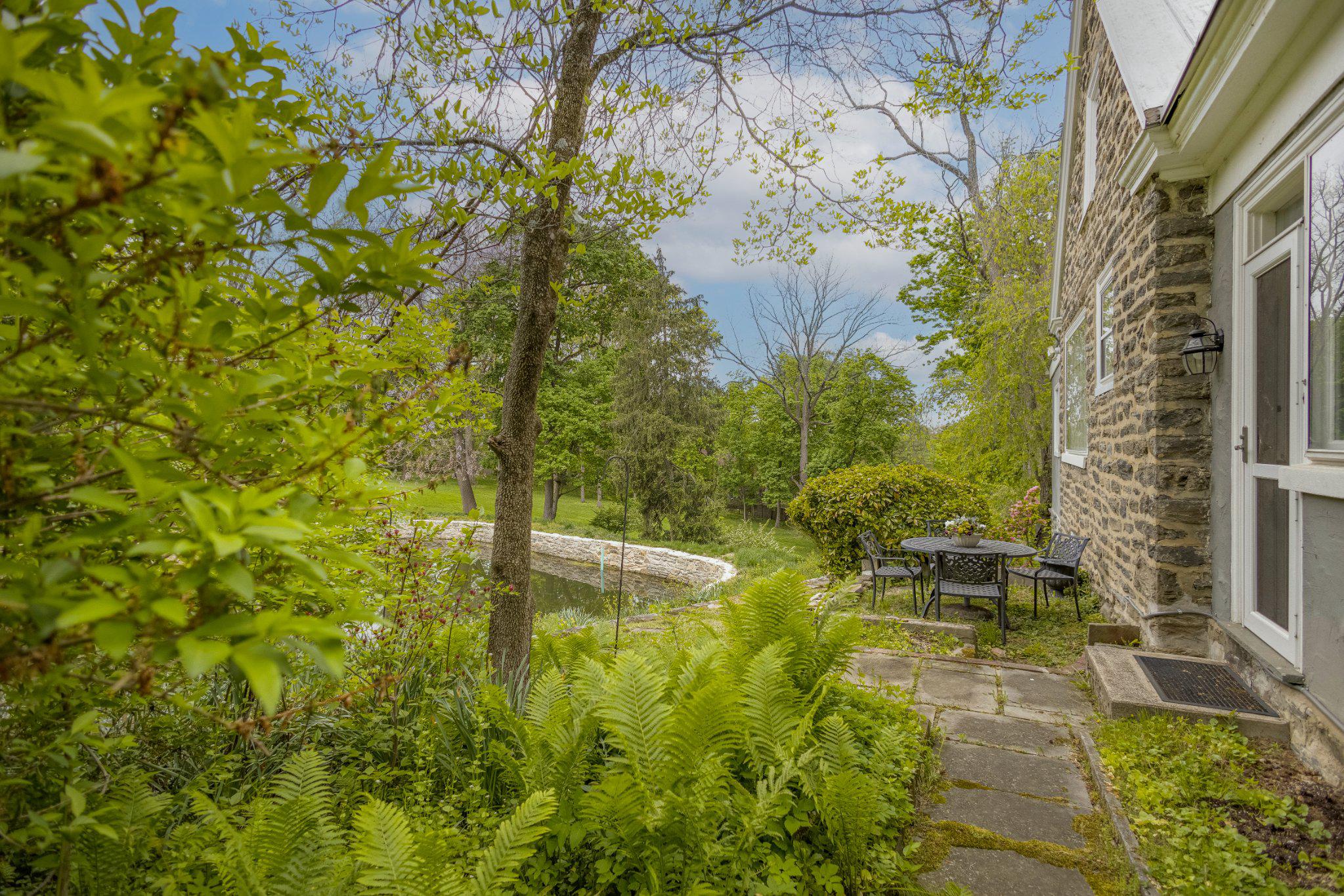 91 East Bells Mill Road Philadelphia, PA 19118 - Photo 15 of 29 Outdoor dining off kitchen with view of pond