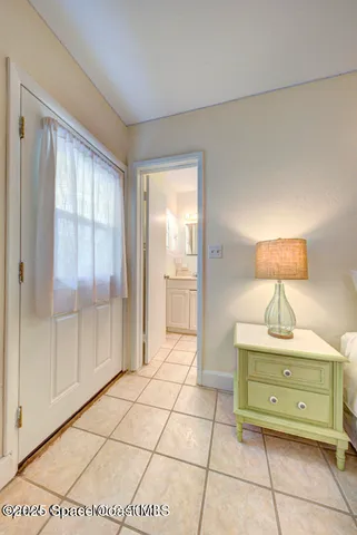 a room with a mirror and a dresser