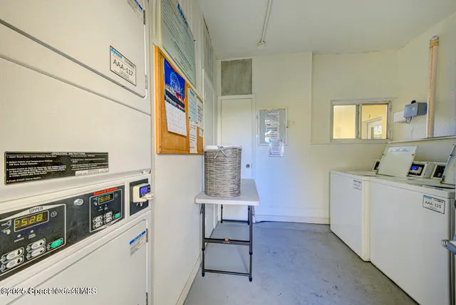 a utility room with cabinets dryer and washer
