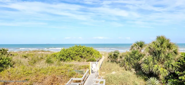 a view of a city with lush green forest