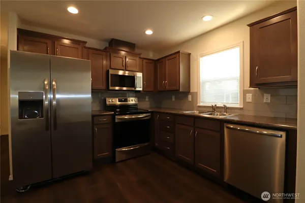 a view of a kitchen with a sink and a window