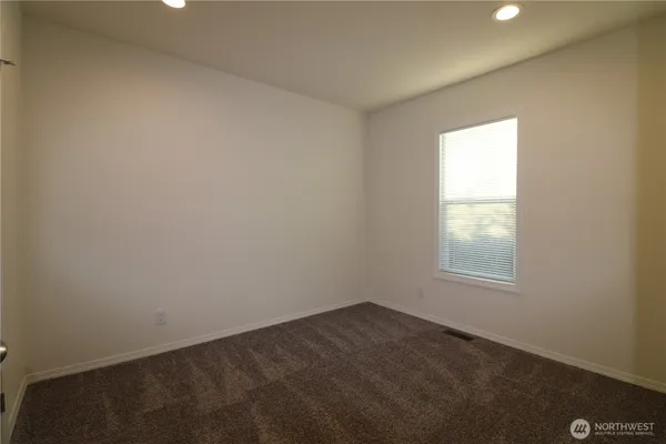 an empty room with closet area