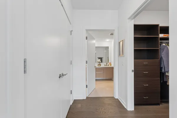 a bathroom with a walk in closet and a shower