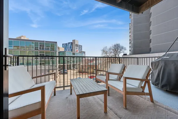 a view of a chairs and a table in the balcony