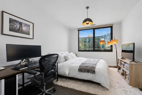 a bedroom with a bed and a flat screen tv