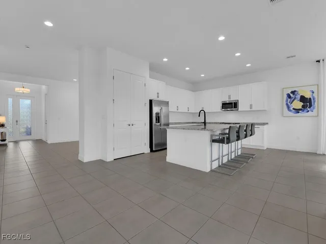 a bathroom with a sink double vanity granite tub and a mirror