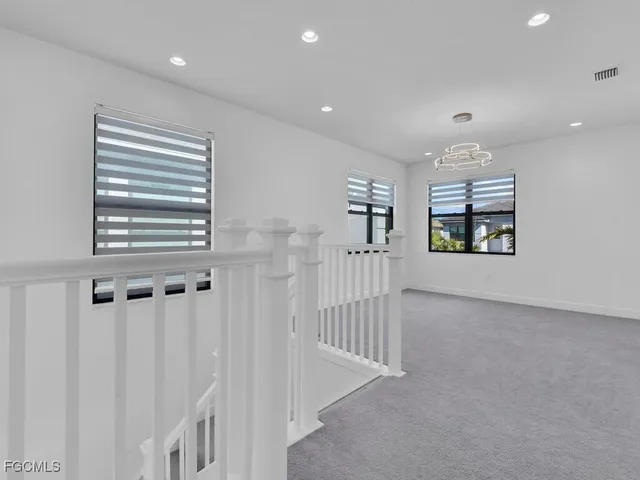 a bedroom with a large bed and a large window