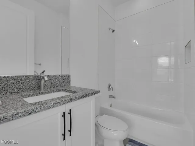 a view of a patio with couches table and chairs potted plants and palm tree