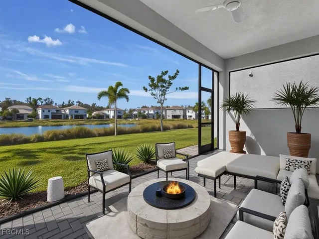 a view of a patio with table and chairs potted plants and large tree
