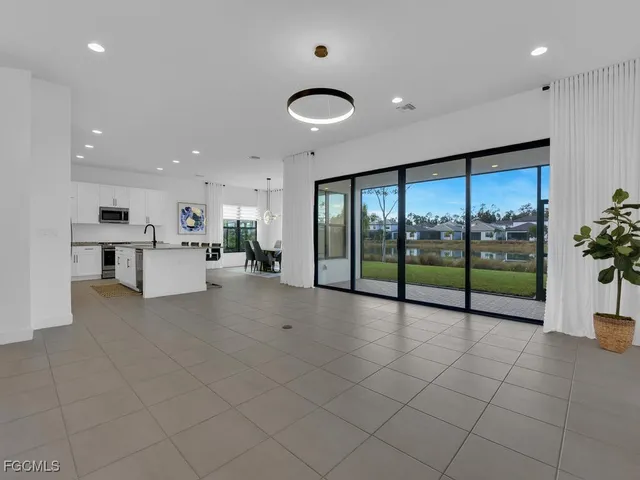 a view of an empty room with a floor to ceiling window and stairs