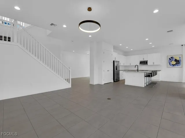 a bathroom with a granite countertop sink a toilet and a mirror