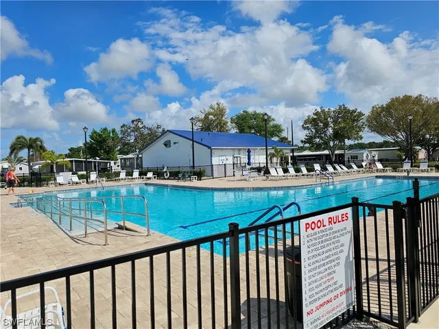 a view of a patio with a table chairs and a fire pit
