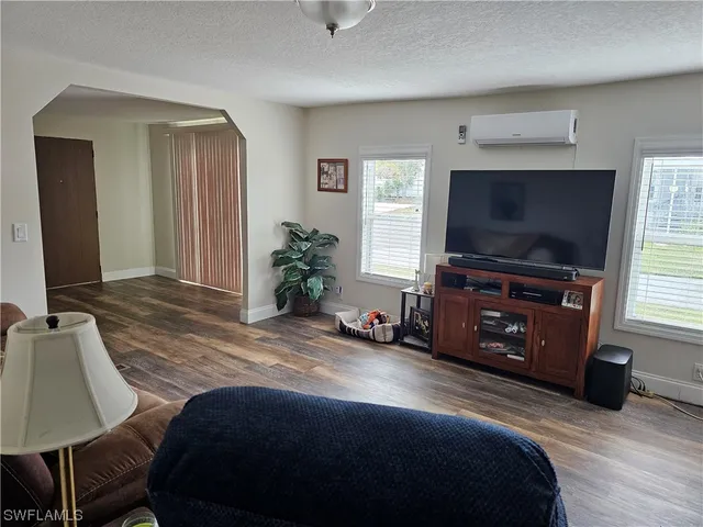 a bedroom with a bed and a flat screen television