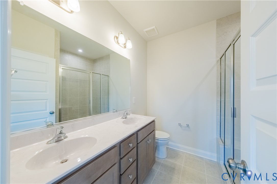 4368 Dominion Forest Circle Glen Allen, VA 23060 - Photo 29 of 36 a bathroom with a sink a toilet and shower