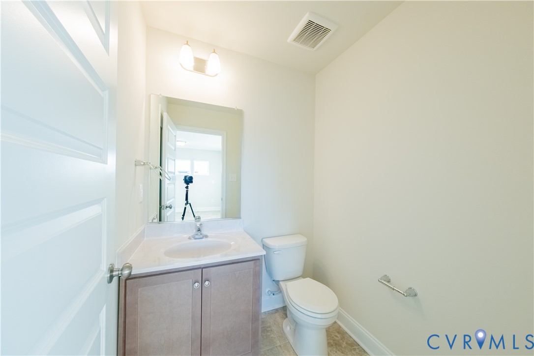 4368 Dominion Forest Circle Glen Allen, VA 23060 - Photo 33 of 36 a bathroom with a toilet sink and mirror