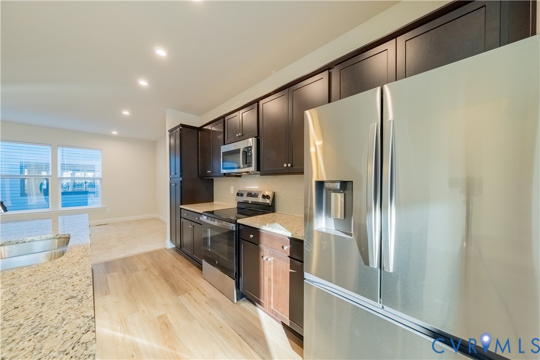 4368 Dominion Forest Circle Glen Allen, VA 23060 - Photo 10 of 36 a kitchen with stainless steel appliances granite countertop a refrigerator a stove and a sink